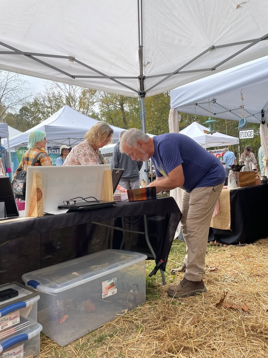 D. E. Johnston at his table at an outdoor market